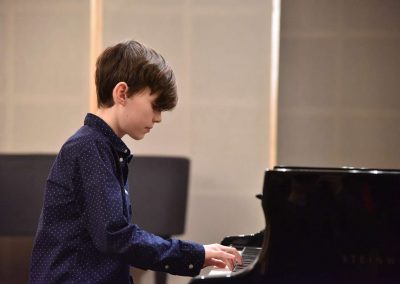 Galerie HAMU, Galerie HAMU, klavírní koncert 11.2.2020.. Žák hrající na klavír - chlapec.