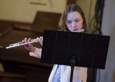 Dechový koncert, Profesní dům MFF, žačka hrající na flétnu.