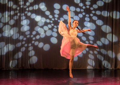 Závěrečné představení tanečního oboru, 14.6.2023, Divadlo U Hasičů, sólistka tančící baletní figuru na pódiu.